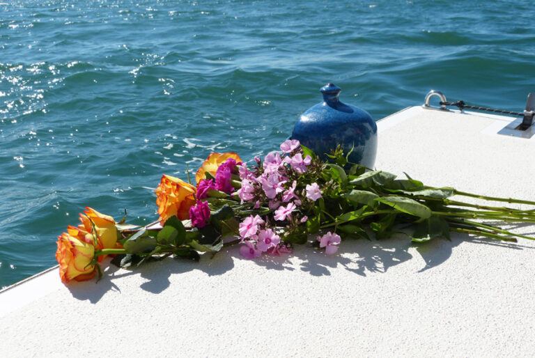 Bouquet de fleurs et urne sur un bateau pour la dispersion des cendres en mer